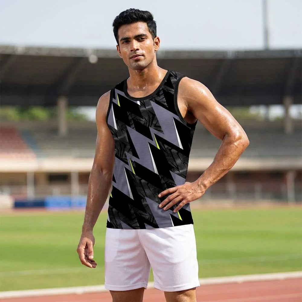 Model wearing black and grey zigzag singlet with lime accents and white shorts at a sports stadium