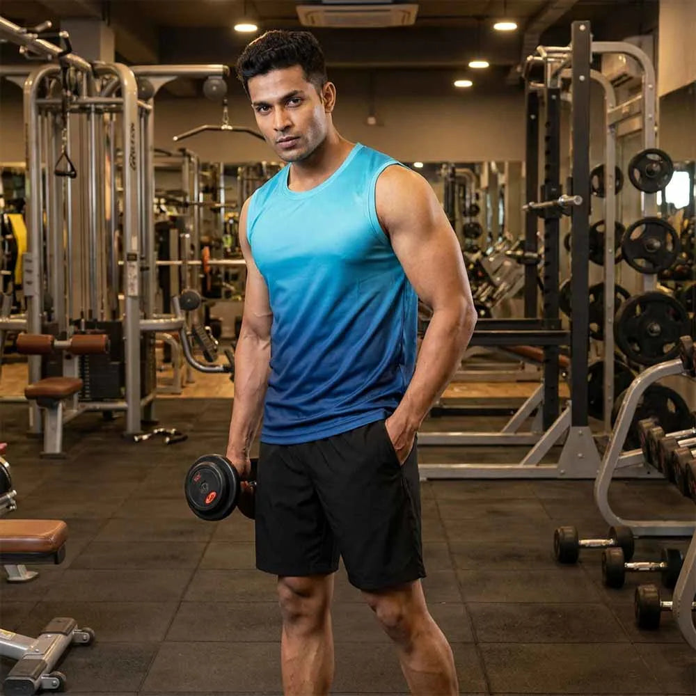 Model wearing turquoise-to-navy gradient singlet and black shorts in a gym