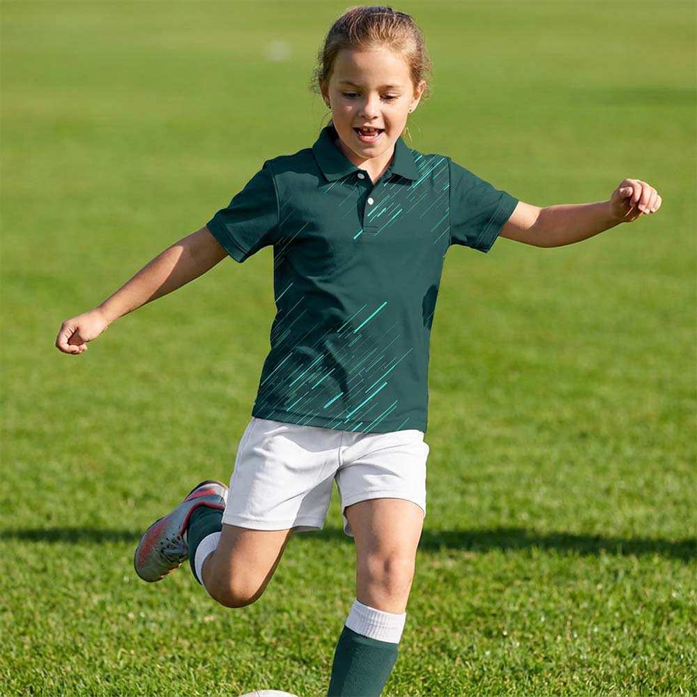 Kids' polo sports jersey in forest green with teal diagonal streaks, worn by a child in white shorts with a football on grass.
