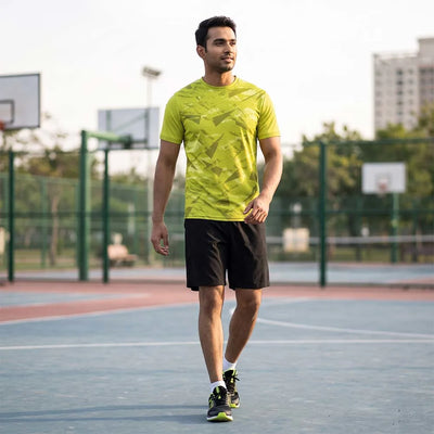 Man on a basketball court wearing a lime yellow abstract-print round-neck jersey and black shorts