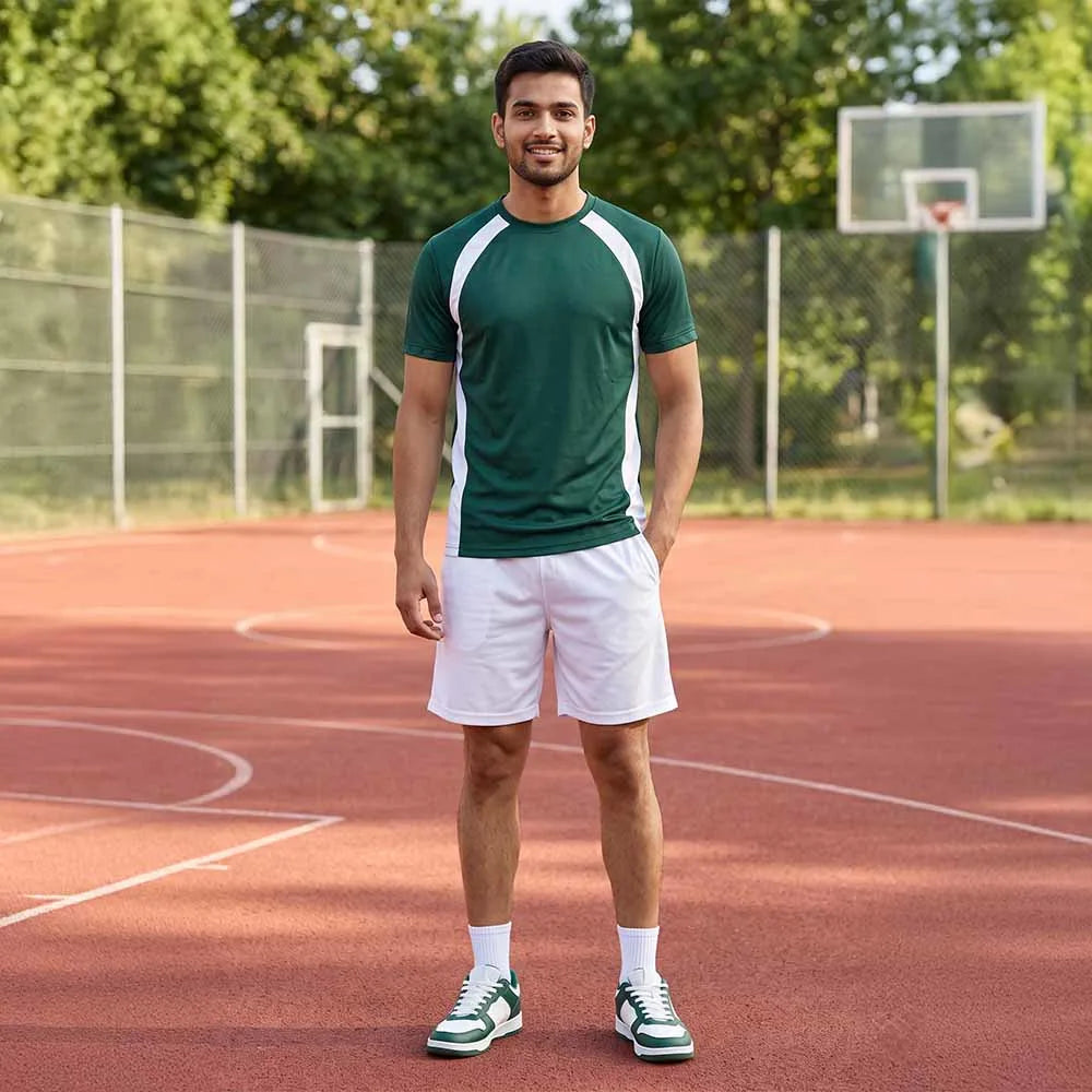 Man on a basketball court wearing a forest green round-neck jersey with white shoulder stripes and white shorts