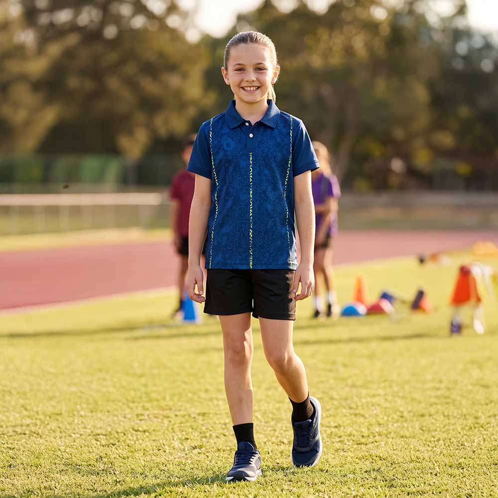 Kids model wearing navy neon maze jersey and black shorts set