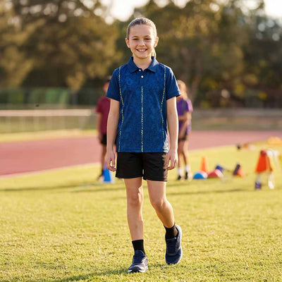 Kids model wearing navy neon maze jersey and black shorts set