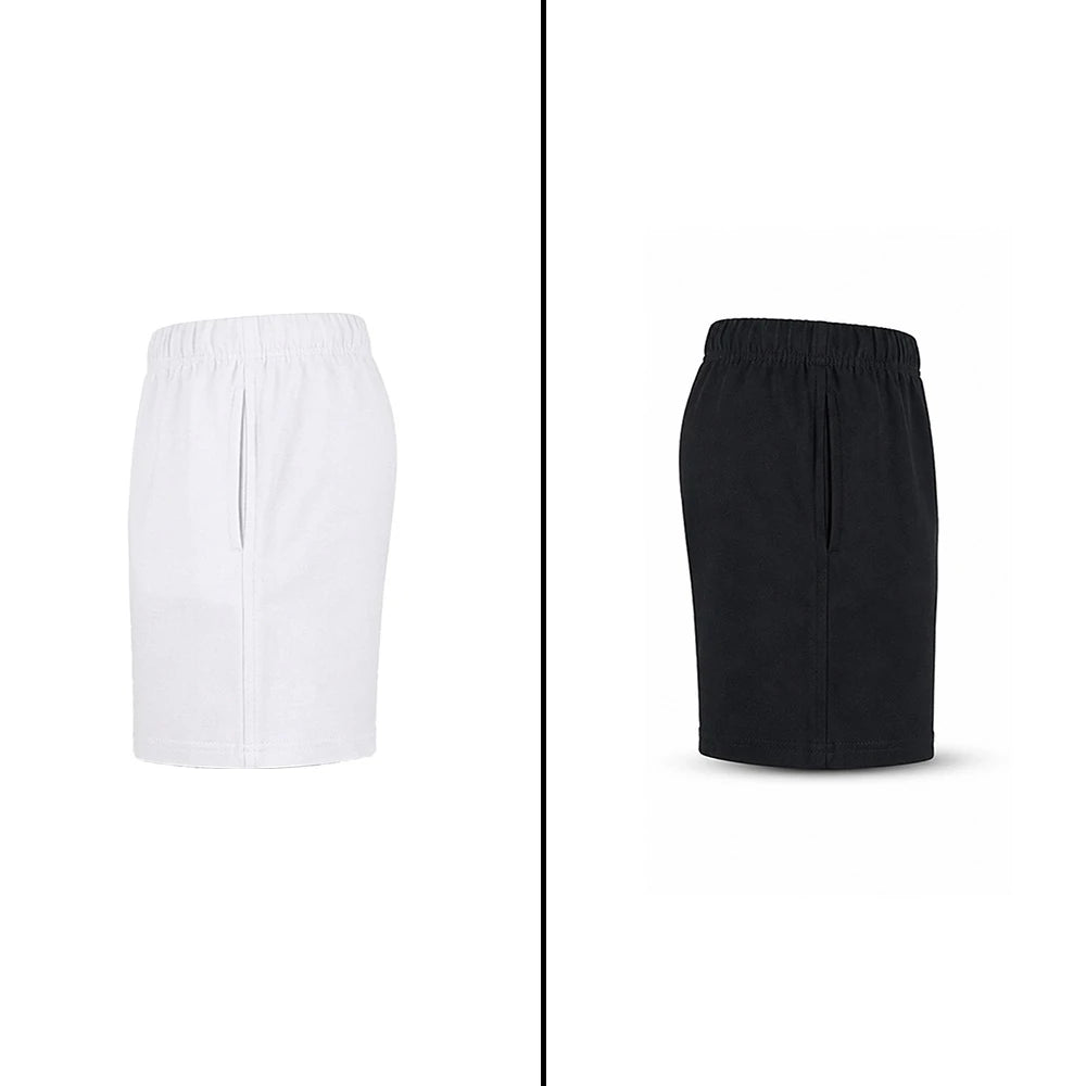 White and black kids’ sports shorts shown side by side in side views.